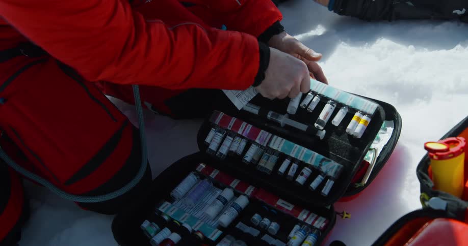 A rescue worker goes through a bag full of medical supplies