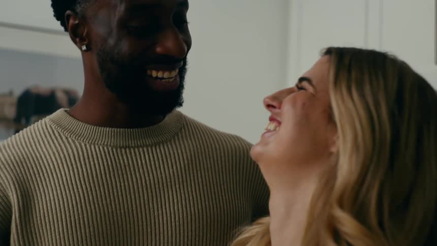 A man and woman talk and laugh