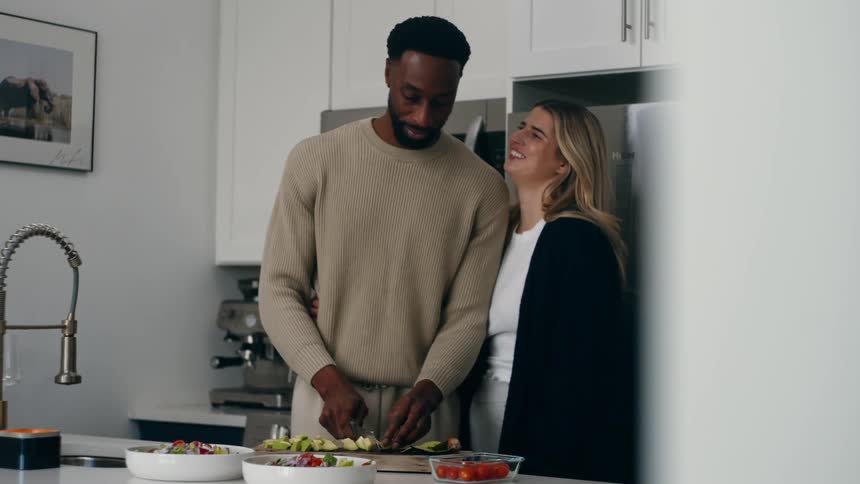 Couple together in the kitchen cooking