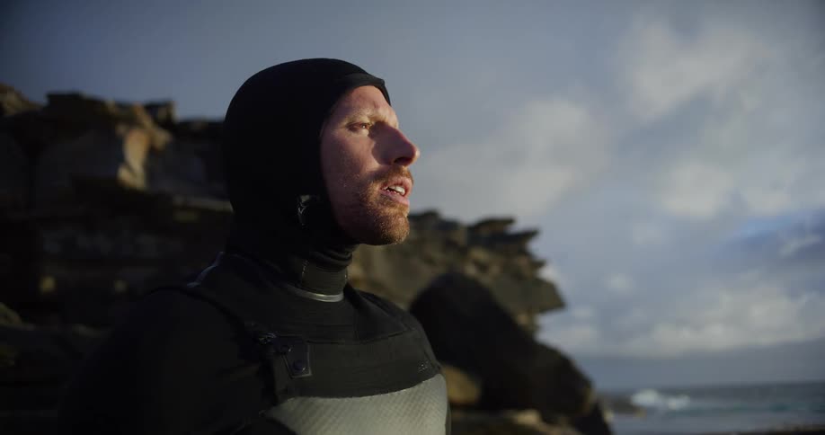 Man in swimming suit concentrated on seashore
