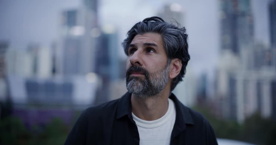 A man is looking around on a cloudy day