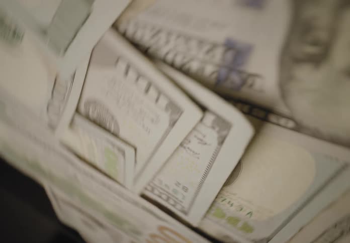 Money bills disposed over a surface indoors