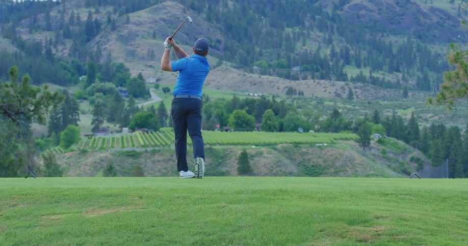 Man in cap on a field playing golf