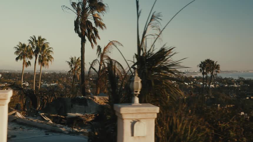 The aftermath of a fire in a neighborhood leaving behind burned and crumbled facades