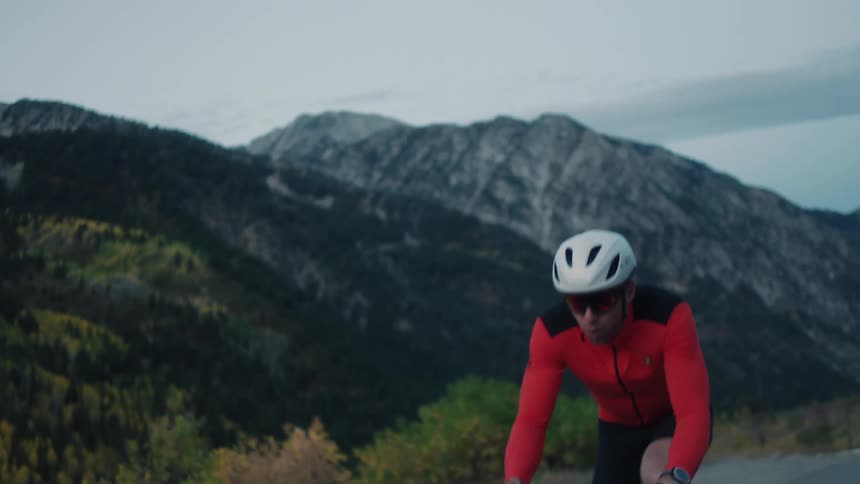 A man is cycling up a mountain road