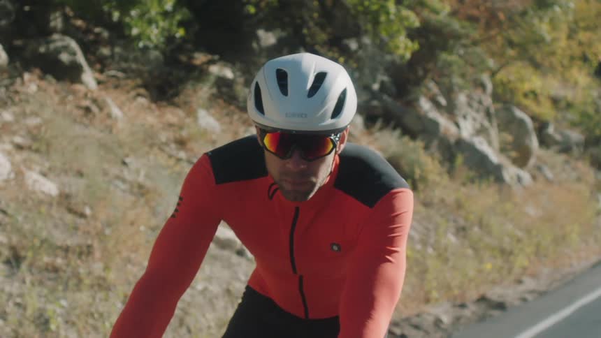 Man in helmet and sports glasses cycling