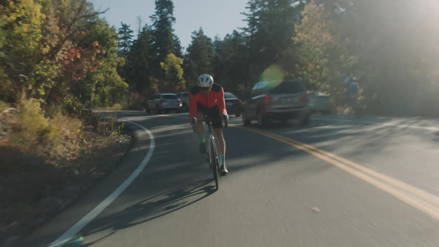 A man is riding his bicycle on the mountain road