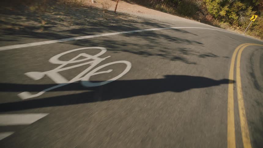 Shadow of a person running on an asphalt