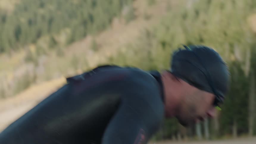 A man is washing off in a lake in the mountains