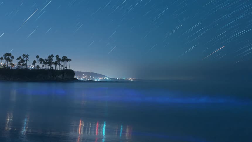 Shooting stars reflect in the water