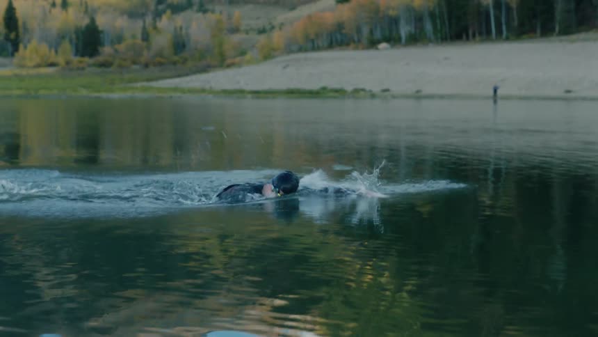 Person swimming at high intensity in a lake
