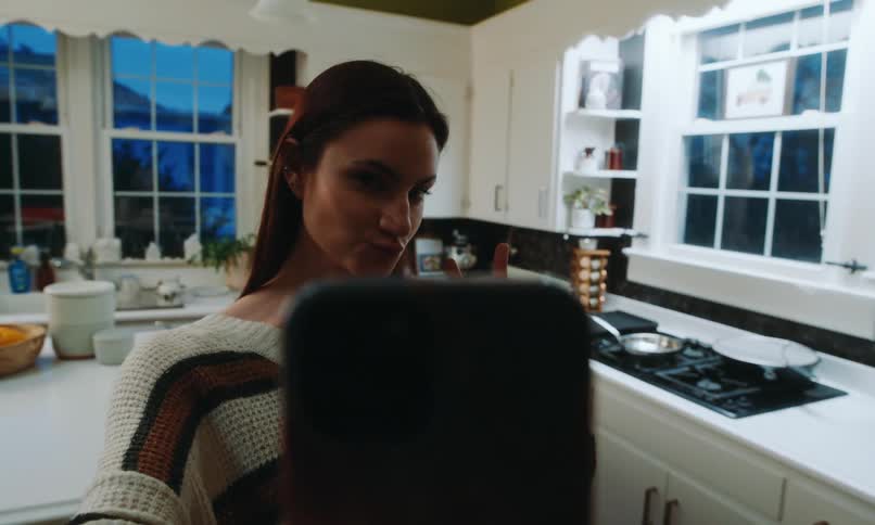 Woman in the kitchen taking a selfie
