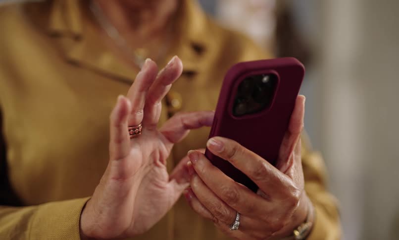 Pair of hands of a person interacting with an iphone