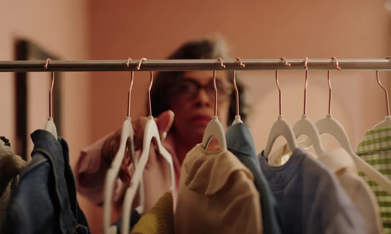 Woman organizing clothes on a hanger