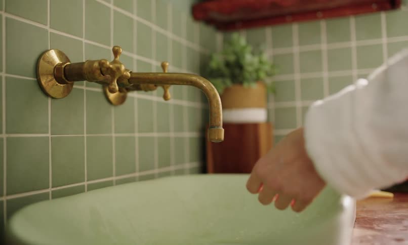 A clip of a person washing hands in the bathroom