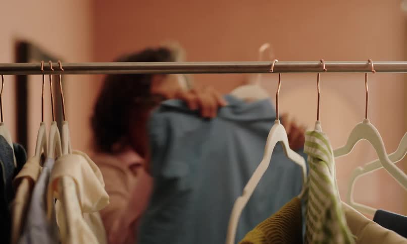 A footage of an elderly woman browsing through cloths