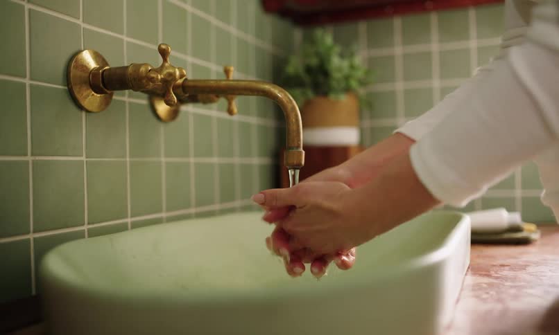 A clip of a person washing hands in the basin