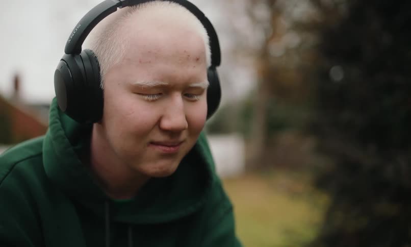 Portrait of a man with closed eyes wearing headphones