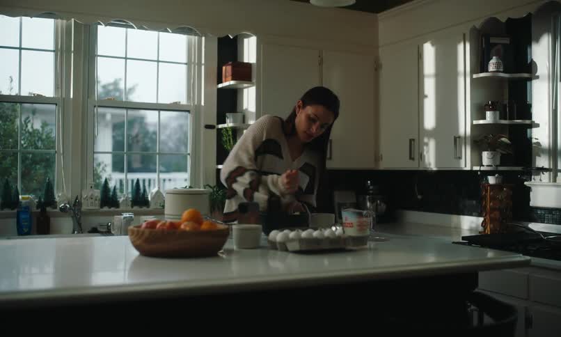 Woman in the kitchen cooking on top of a counter