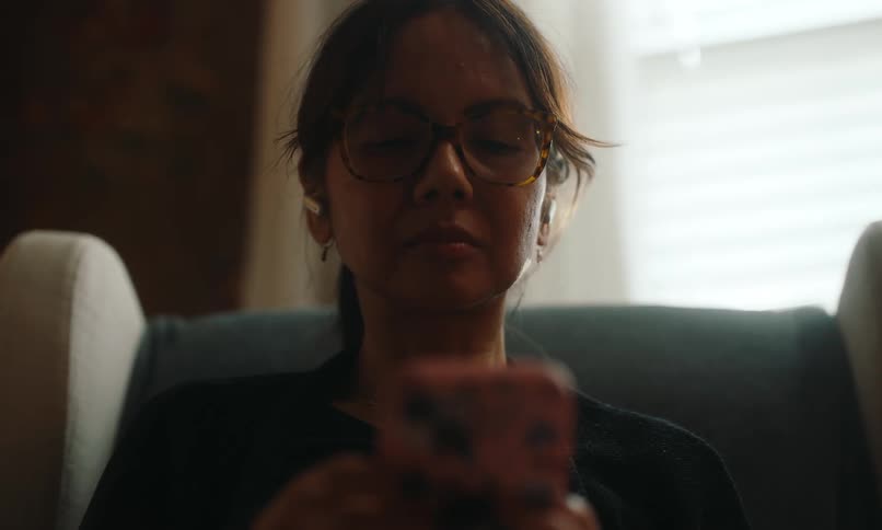 A woman is texting on her cell phone