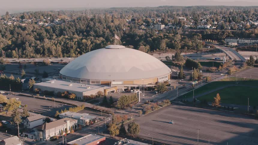 Aerial view of a dome next to a highway in an urban city