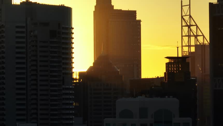 Aerial shot of skyscrapers against a golden sky