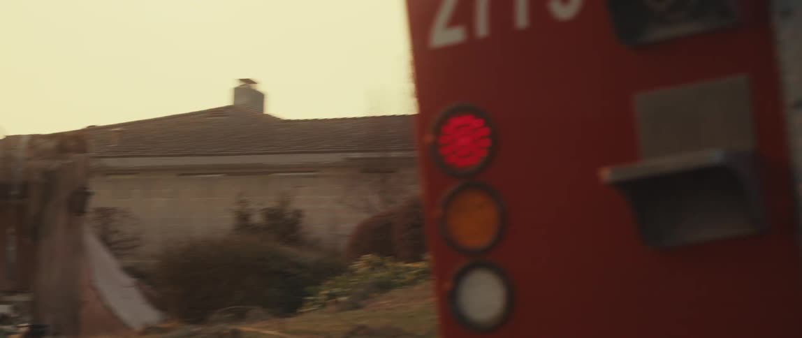 A red fire truck next to a destroyed building