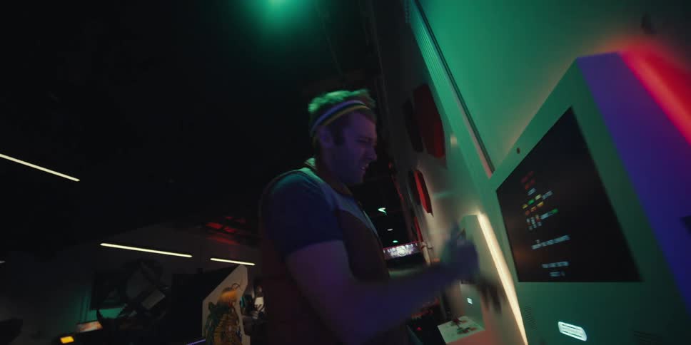 Man having fun and playing on arcade machine