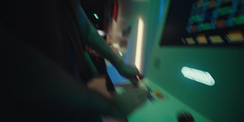 Man makes several expressions while playing an arcade game in an arcade