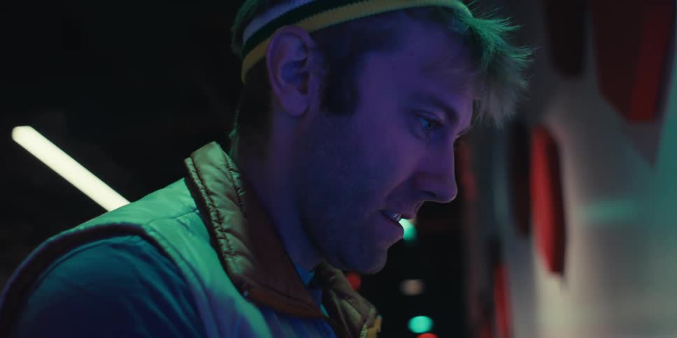A man is smiling and having fun while looking at something