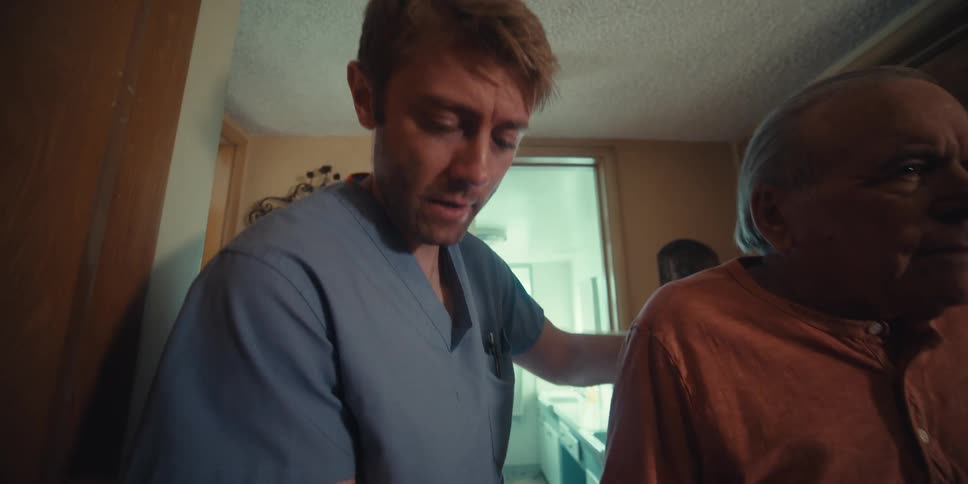 A nurse is helping a man walk at home