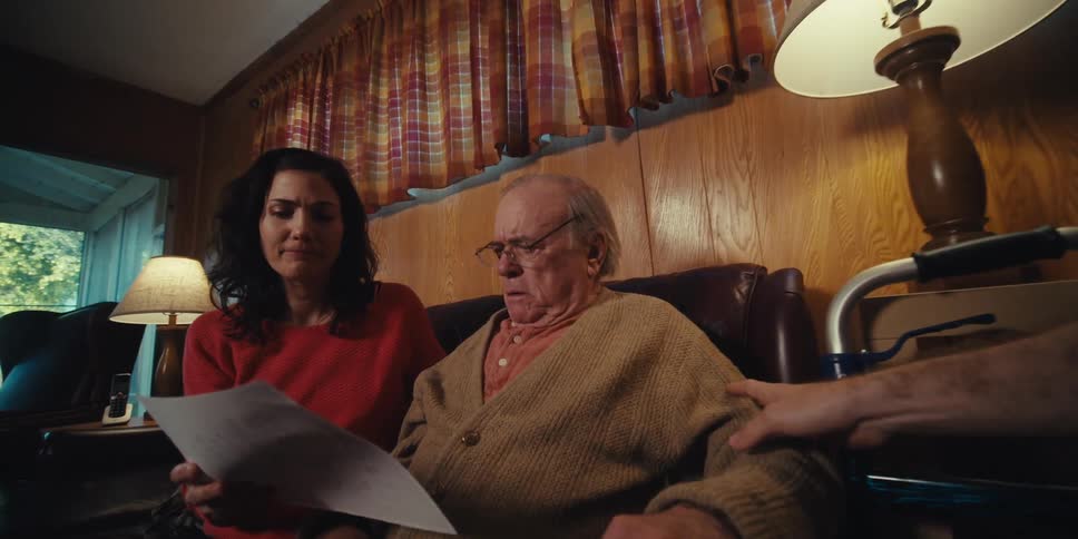 A doctor is looking at medical records with a patient