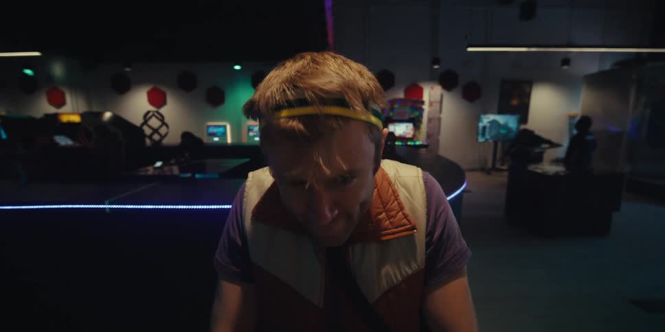 Man shaking his head while playing an arcade game