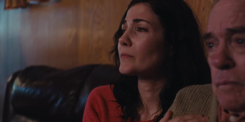 A daughter consoles her crying father