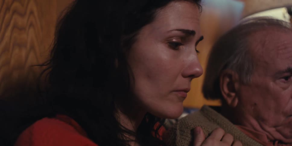 A daughter is consoling her worried father
