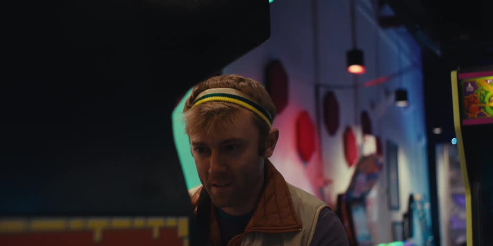 Man having fun playing old arcade machines