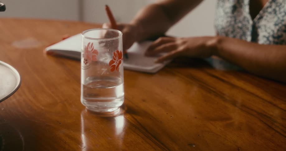 A clip of a person writing on a table