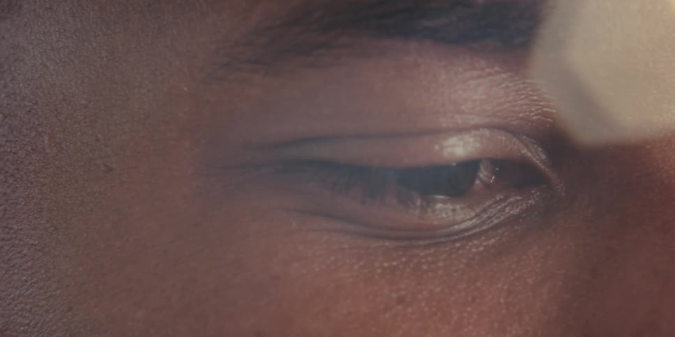 Closeup of a mans eye with sunlight flaring around it