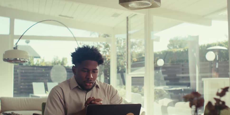 Thoughtful man sitting in front of a laptop