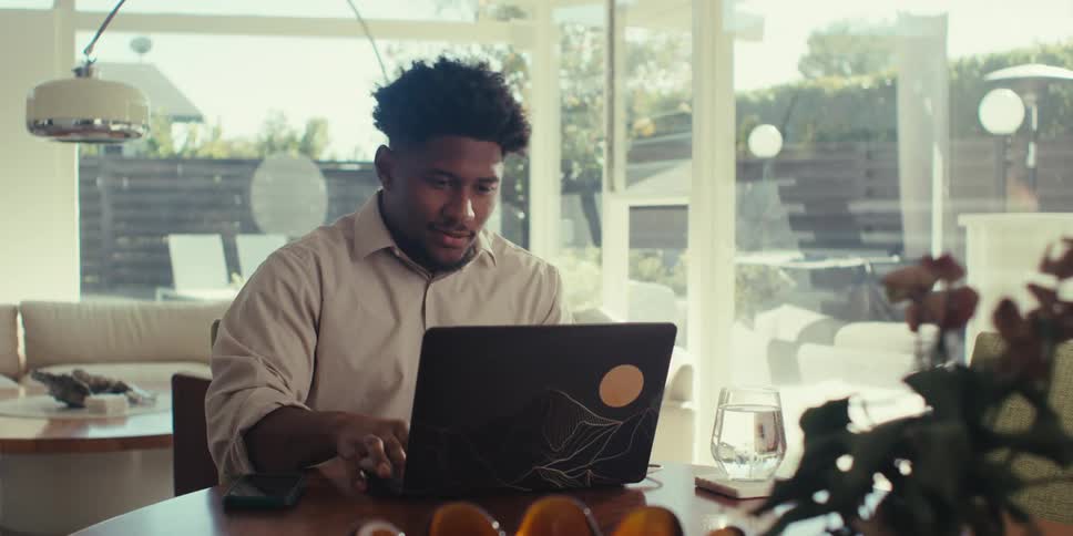 Man sitting typing on a laptop