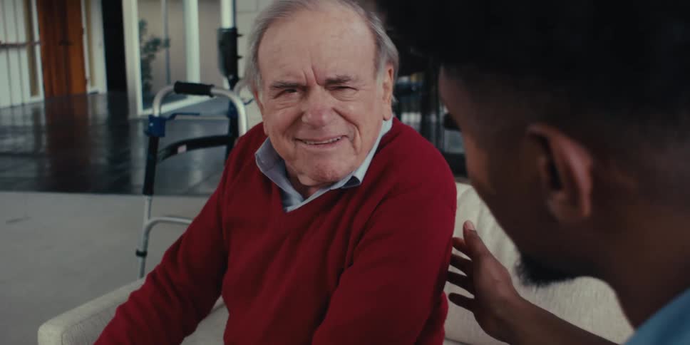 Cheerful elderly patient talking to a nurse