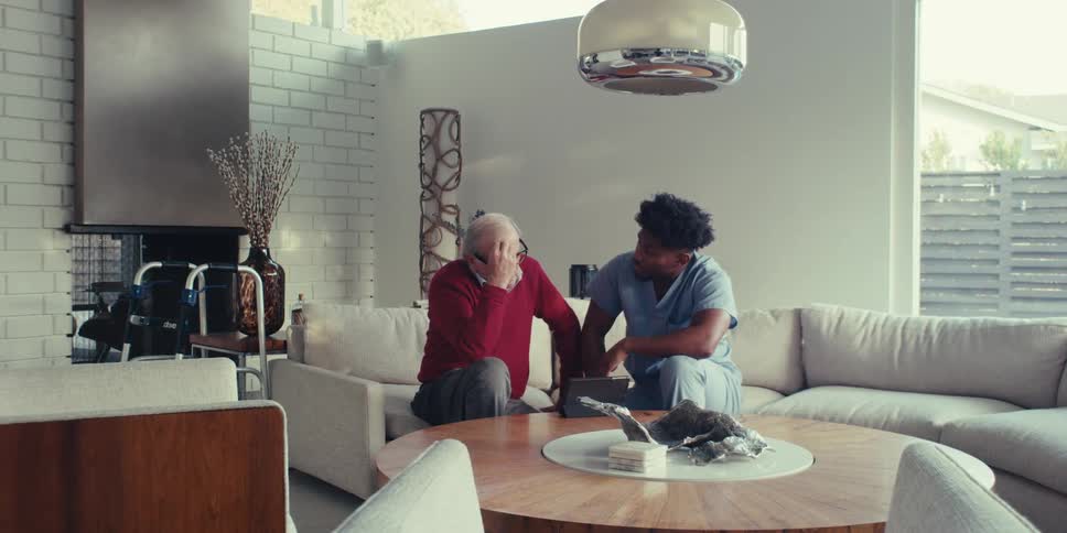 Elderly man talking to a nurse