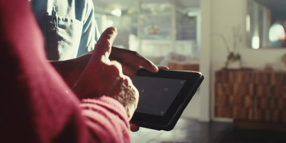 Hands of two people interacting with a tablet with a gray replaceable screen