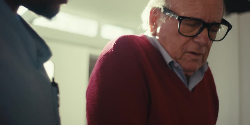 Elderly man walking with a nurse