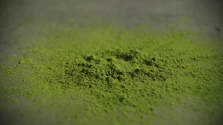 Green powder being poured
