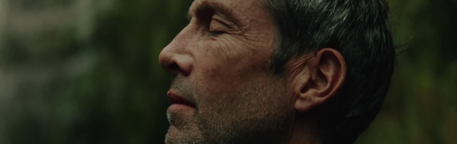 Side portrait of a man in the middle of nature