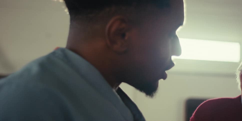 Young adult talking to an elderly man