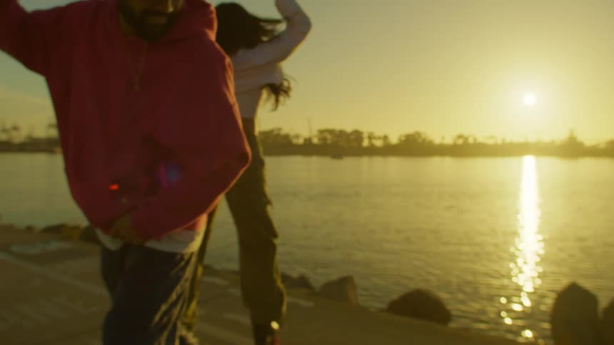 A man and women are having fun dancing on their roller blades