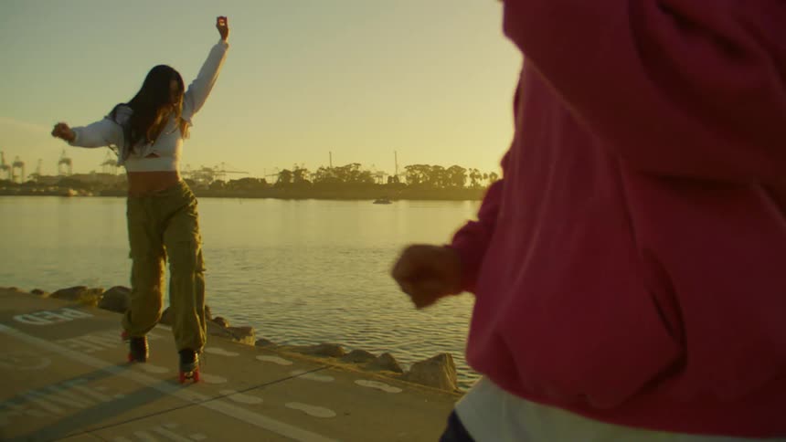 Woman and a man dancing by a lake