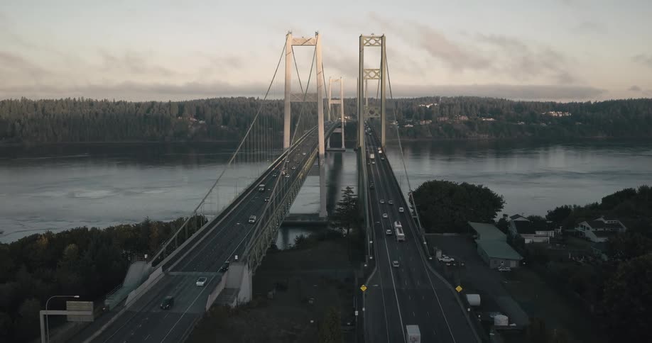 Aerial aerial view of two large bridges with vehicle traffic crossing a sea channel